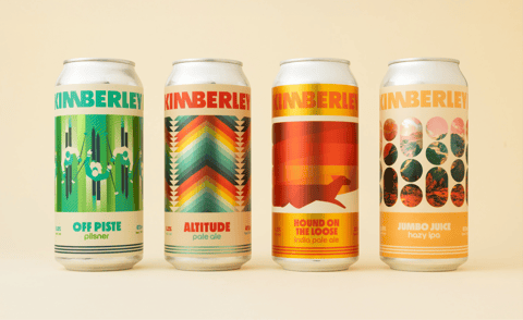 Four Kimberley Brewery beer cans with bold geometric artwork: green skiing design for Off Piste pilsner, rainbow chevrons for Altitude pale ale, red hound silhouette for Hound on the Loose IPA, and orange mountain collage for Jumbo Juice hazy IPA.